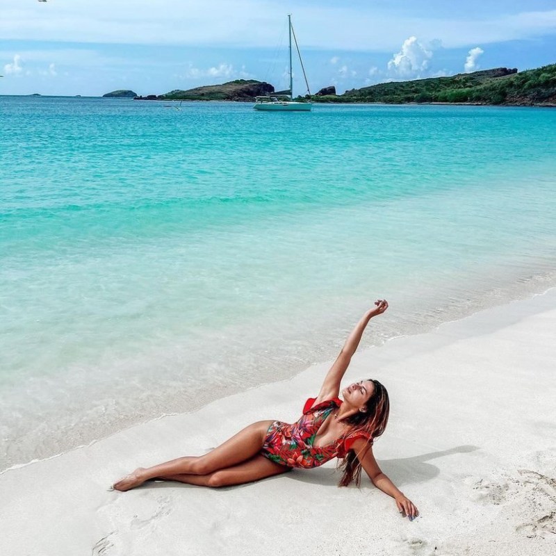 a person standing next to a body of water