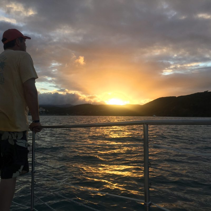 a man standing next to a body of water
