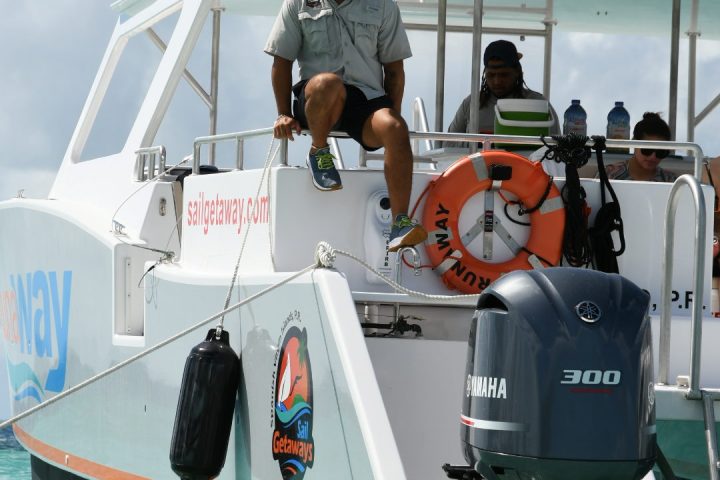 a group of people on a boat in the water