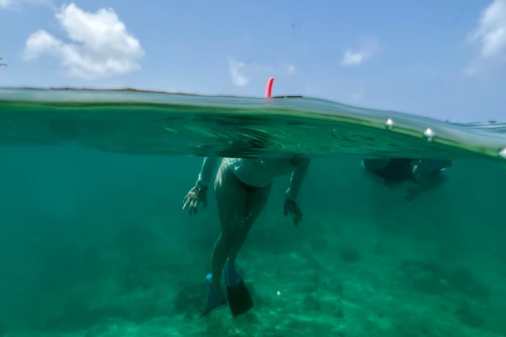 a person riding a wave on a surfboard in the water