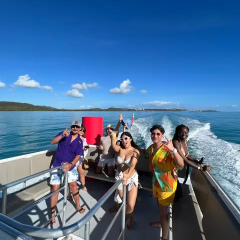 a group of people standing next to a body of water