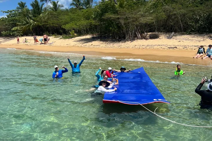 a group of people on a raft in a body of water