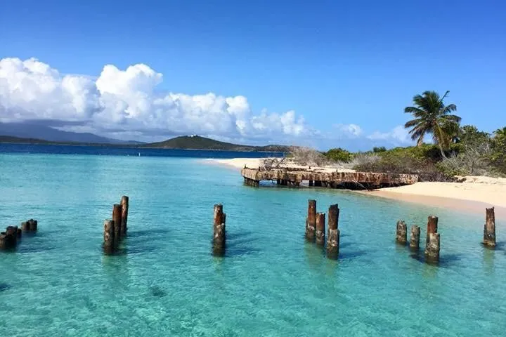 a group of people standing next to a body of water