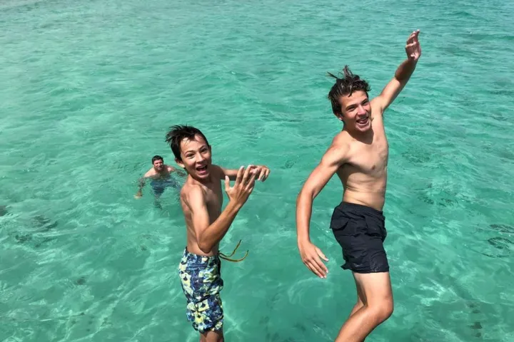 a group of people swimming in a pool of water