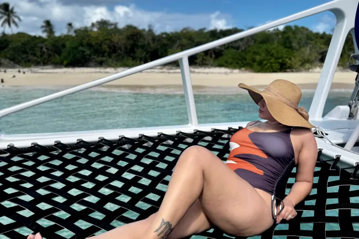 a woman sitting on the keyboard of a laptop